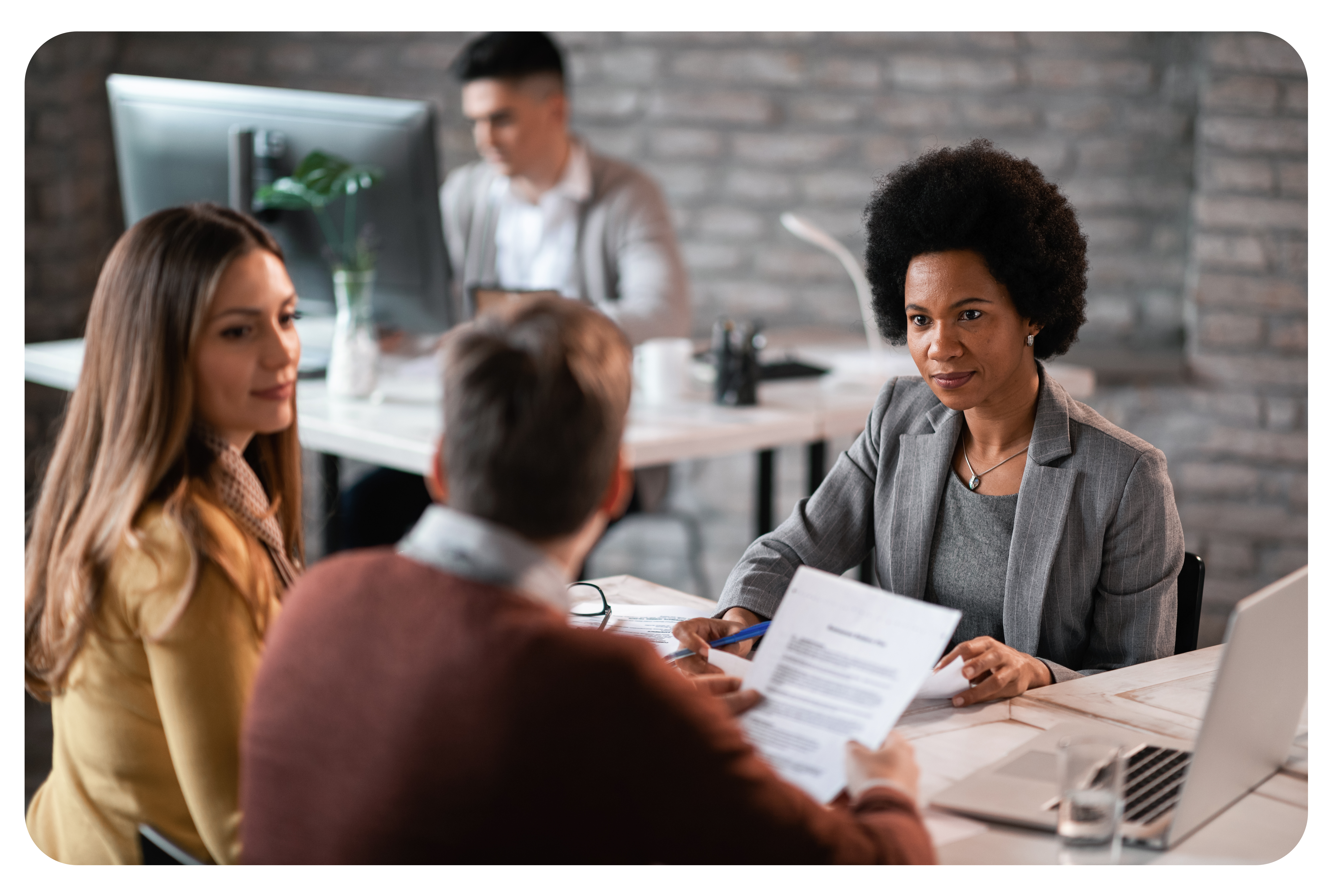 african-american-financial-advisor-going-through-paperwork-with-her-clients-while-having-meeting-office